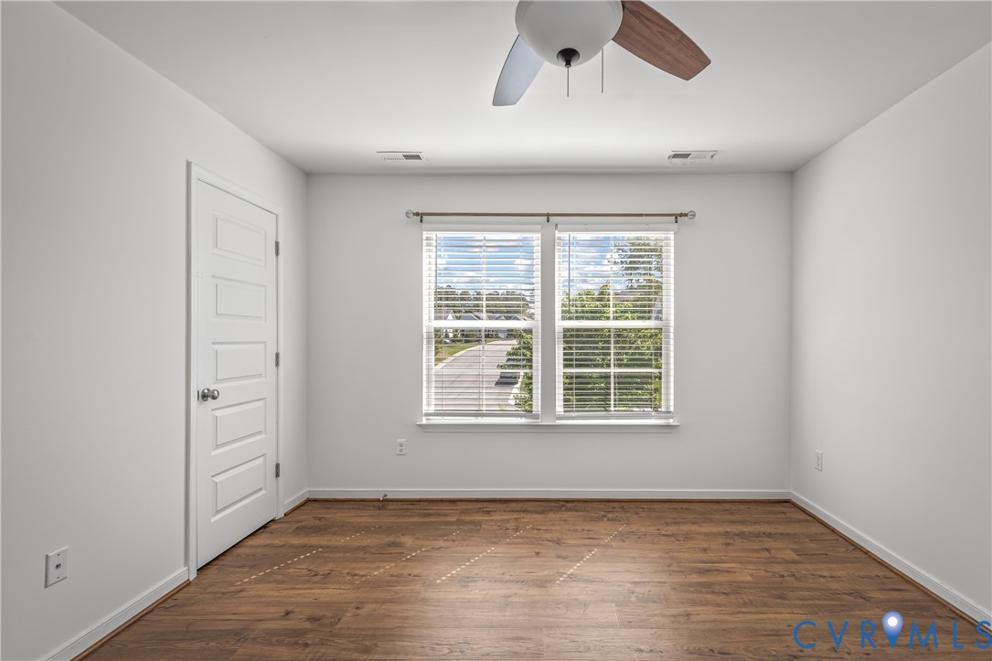 8200 Timberstone Drive Chesterfield, VA 23832 - Photo 32 of 42 a view of an empty room with a window and wooden floor