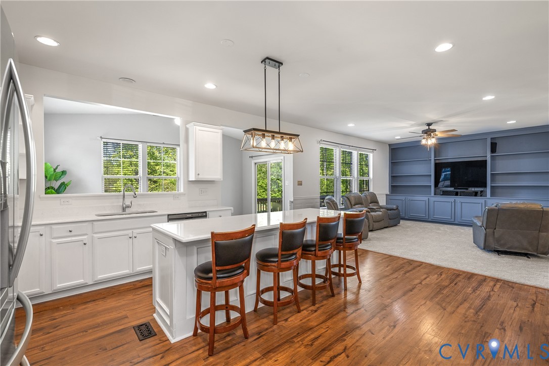 8200 Timberstone Drive Chesterfield, VA 23832 - Photo 8 of 42 a kitchen with sink cabinets and wooden floor