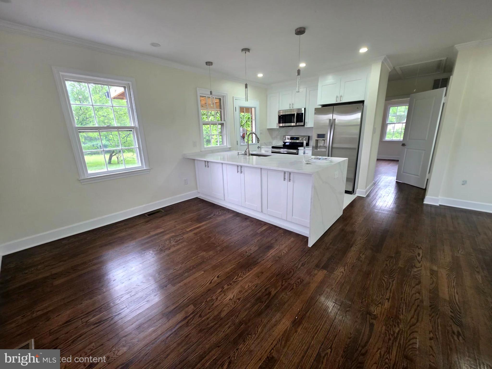 2206 Brinkley Road Fort Washington, MD 20744 - Photo 43 of 78 a kitchen with stainless steel appliances wooden floors and white walls