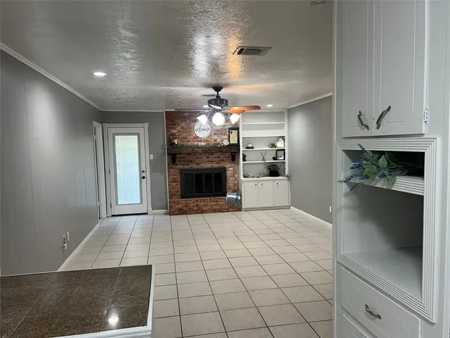 a view of a kitchen with a sink and refrigerator
