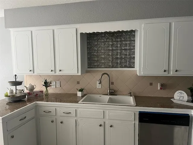 a kitchen with stainless steel appliances granite countertop a sink stove and cabinets