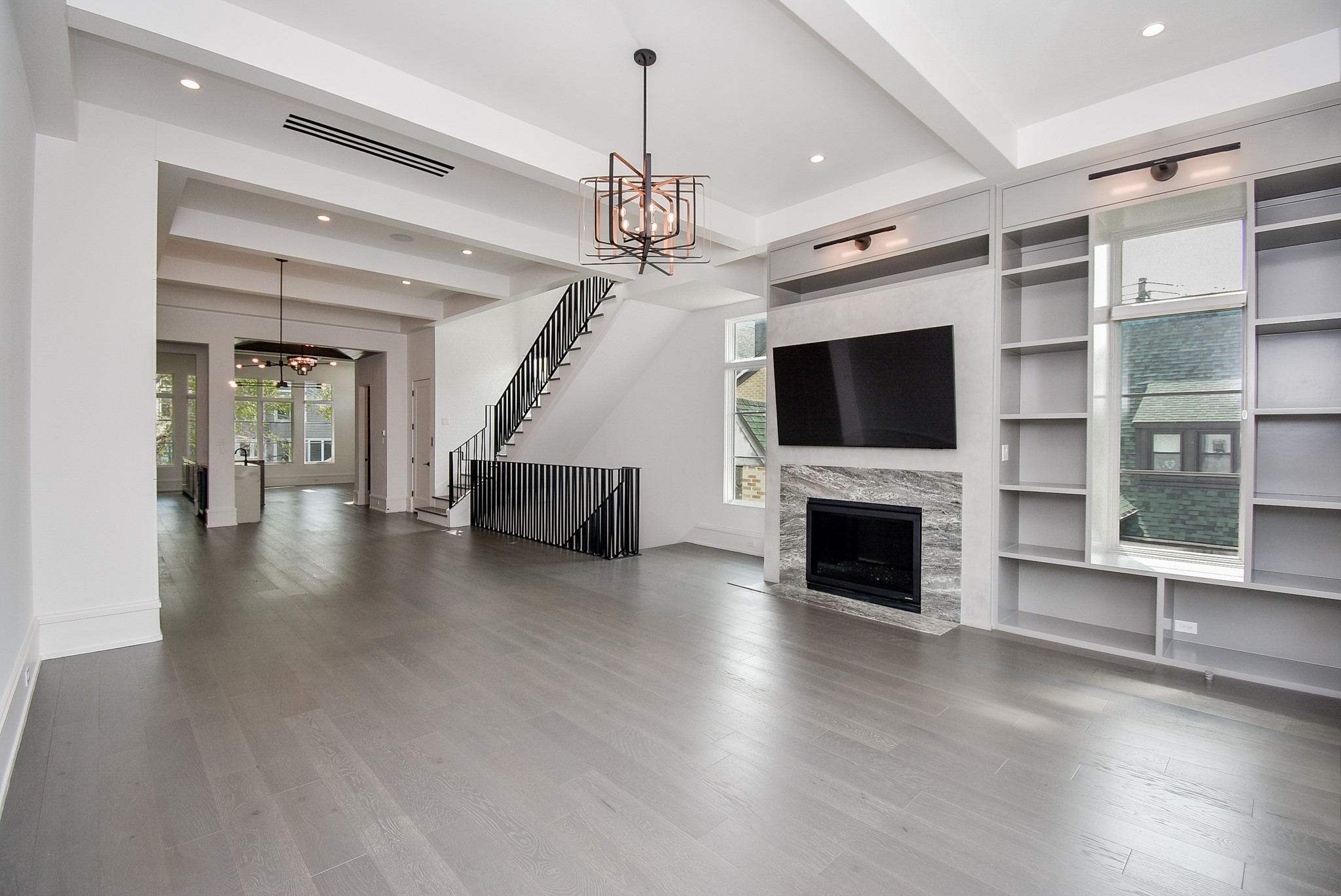1107 Berthea Street, Unit B Houston, TX 77006 - Photo 14 of 50 a view of a livingroom with a fireplace a chandelier and wooden floor