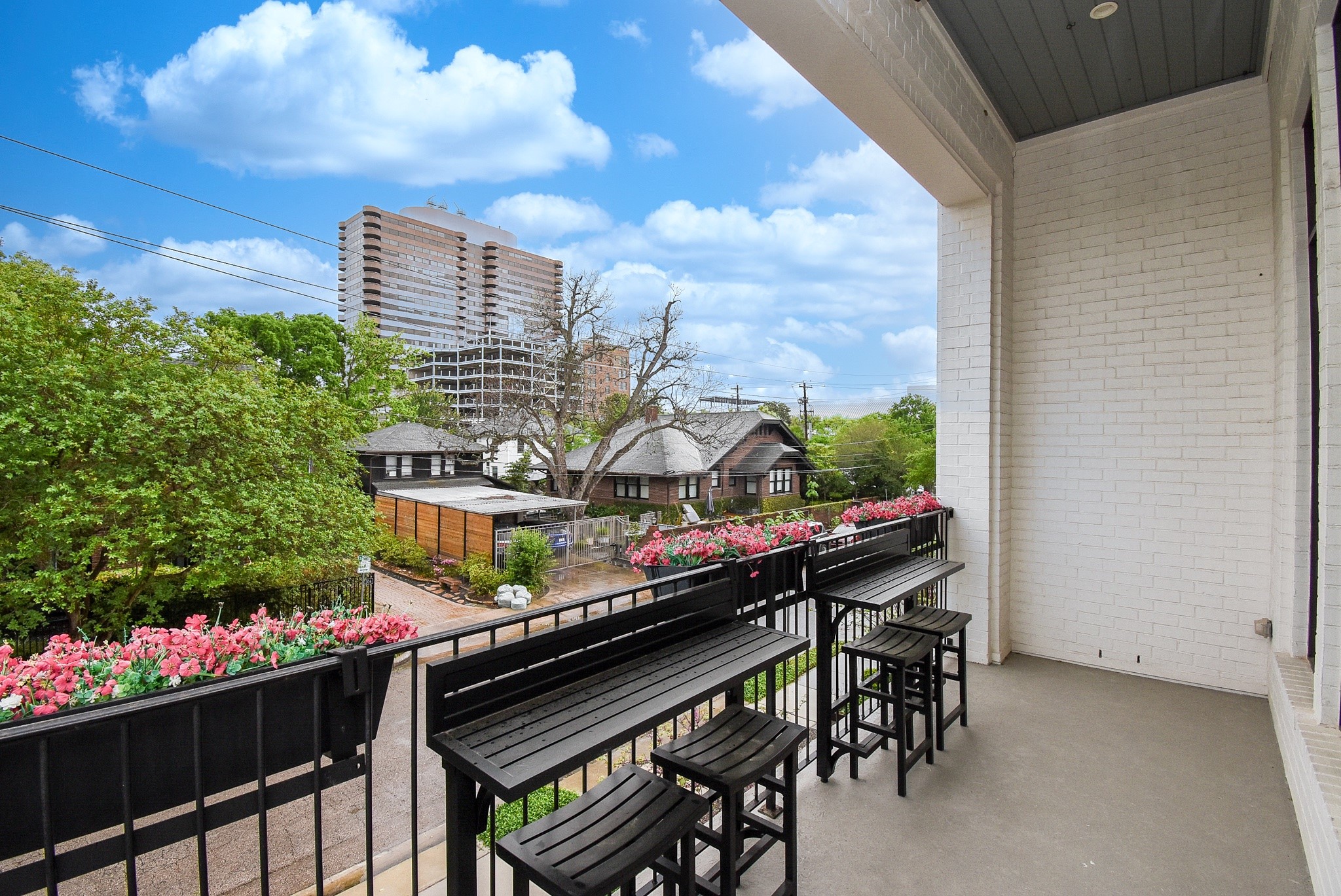 1107 Berthea Street, Unit B Houston, TX 77006 - Photo 29 of 50 a city view from a balcony with chairs