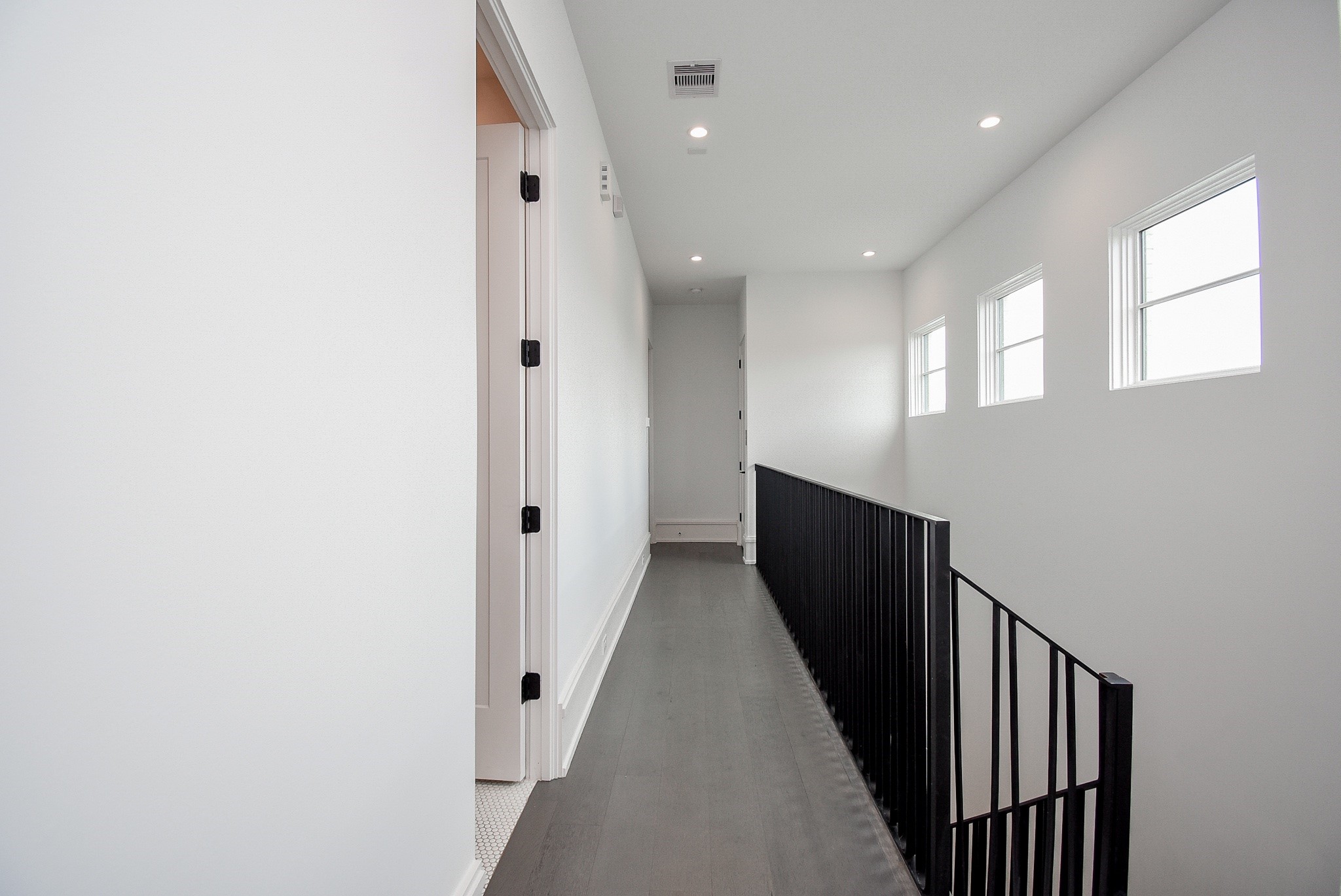 1107 Berthea Street, Unit B Houston, TX 77006 - Photo 31 of 50 a view of a hallway with wooden floor