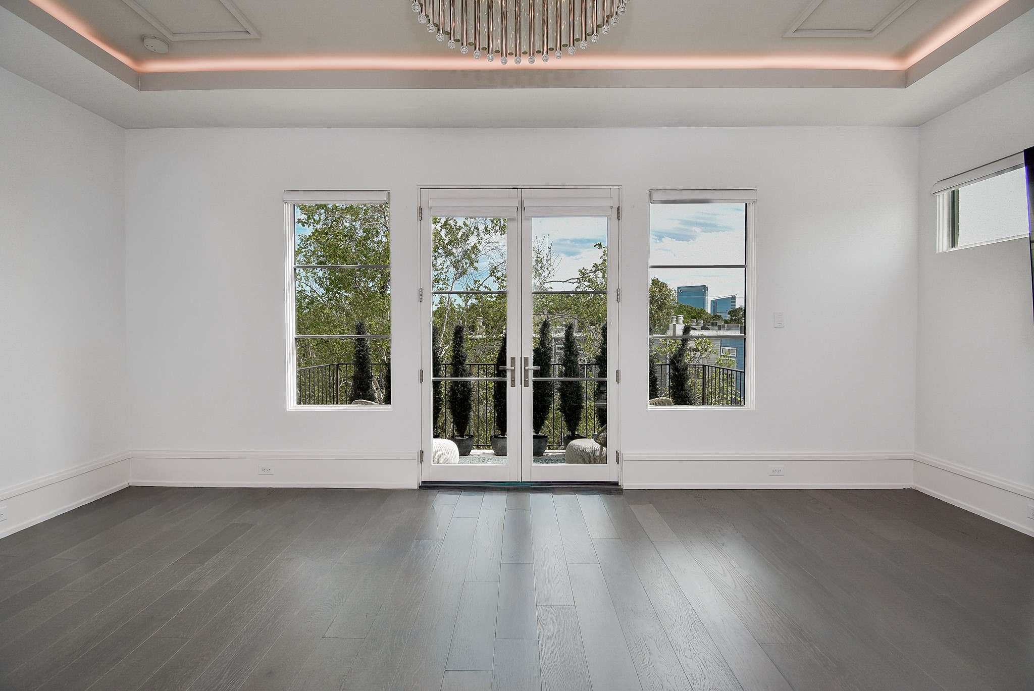 1107 Berthea Street, Unit B Houston, TX 77006 - Photo 33 of 50 a view of wooden floor and windows in a room
