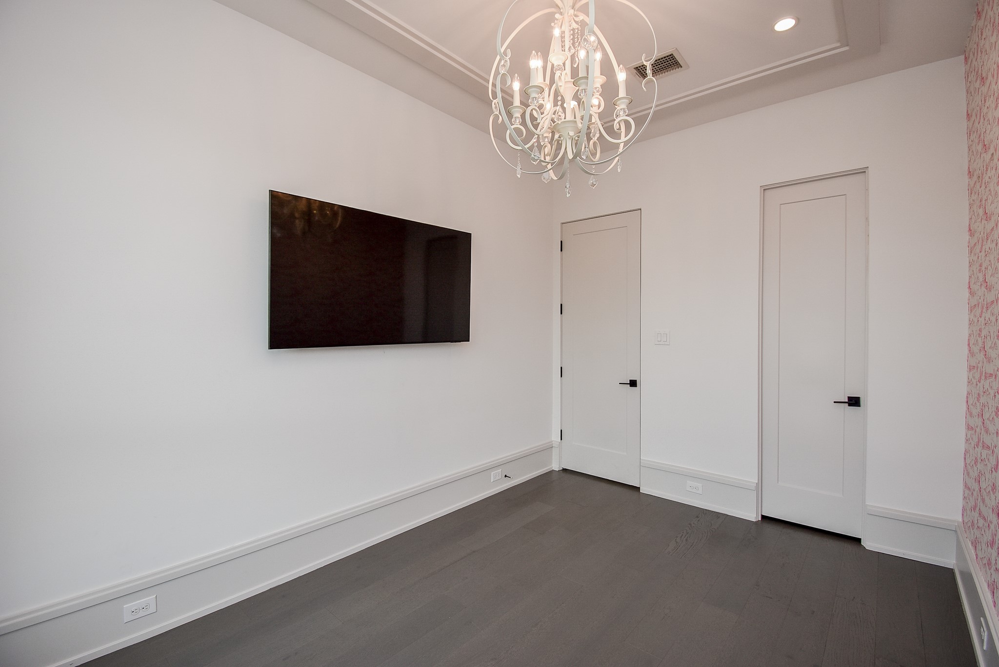 1107 Berthea Street, Unit B Houston, TX 77006 - Photo 41 of 50 a living room with a flat screen tv and a chandelier