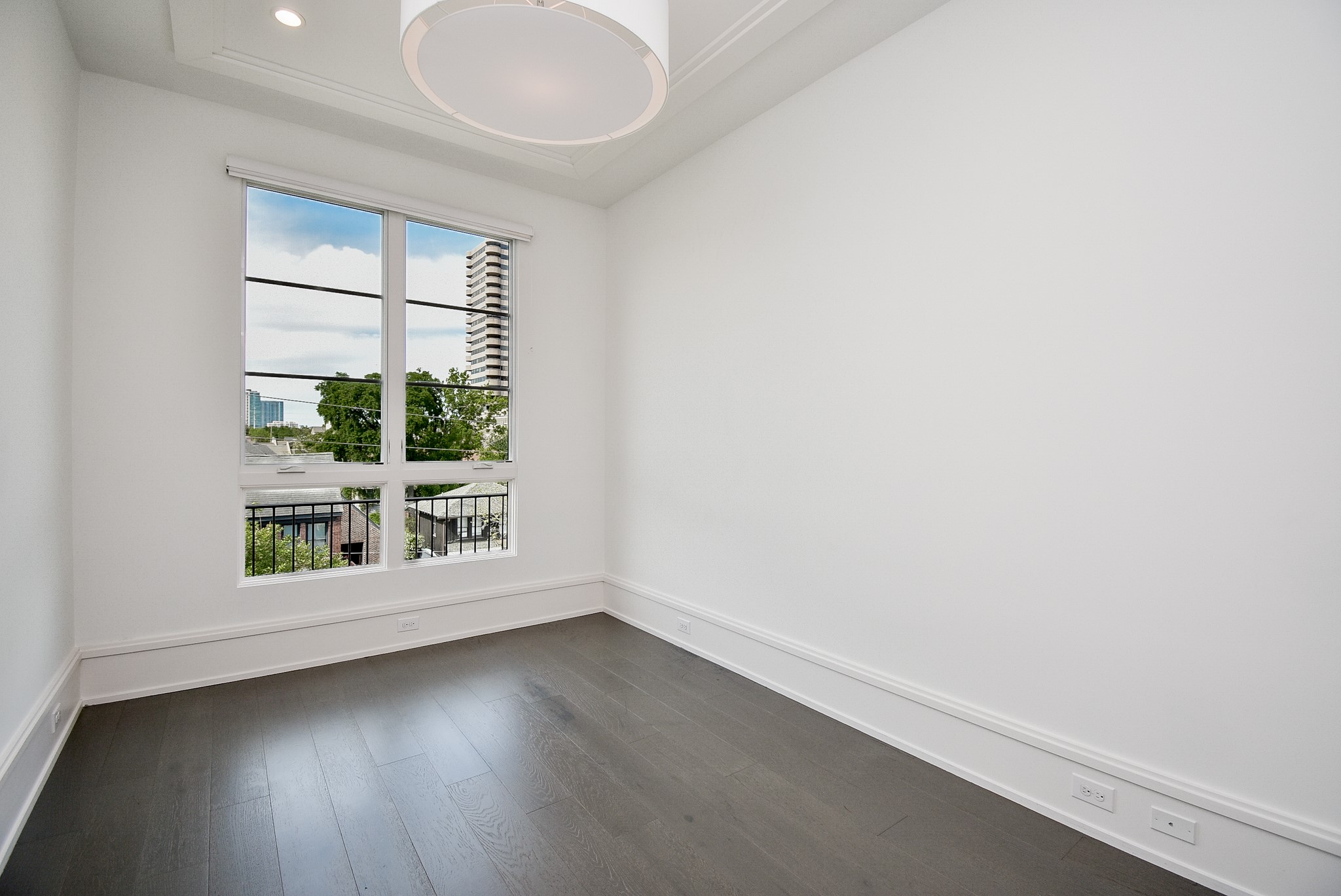 1107 Berthea Street, Unit B Houston, TX 77006 - Photo 44 of 50 an empty room with wooden floor and windows