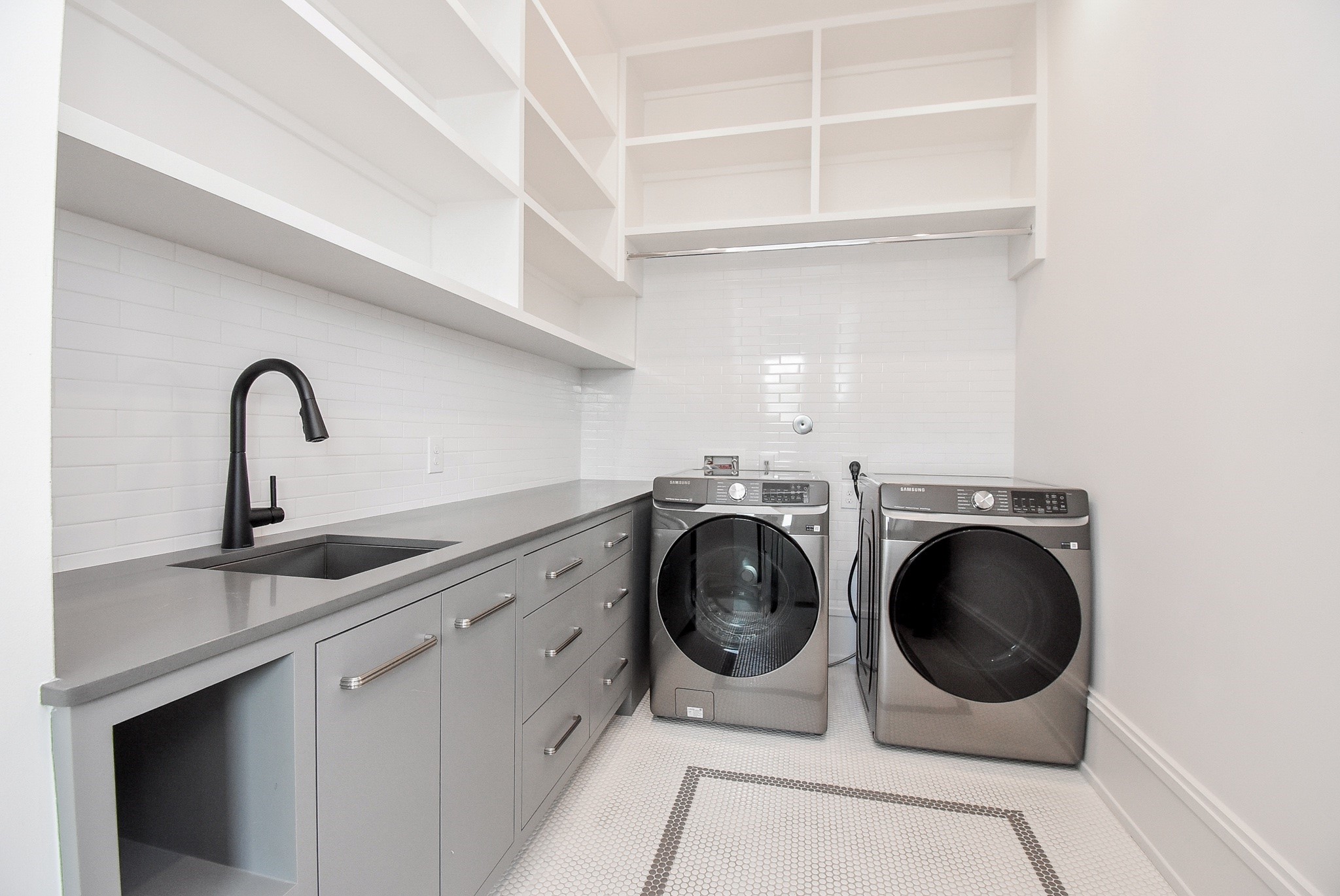 1107 Berthea Street, Unit B Houston, TX 77006 - Photo 46 of 50 a close view of a sink and a washer dryer