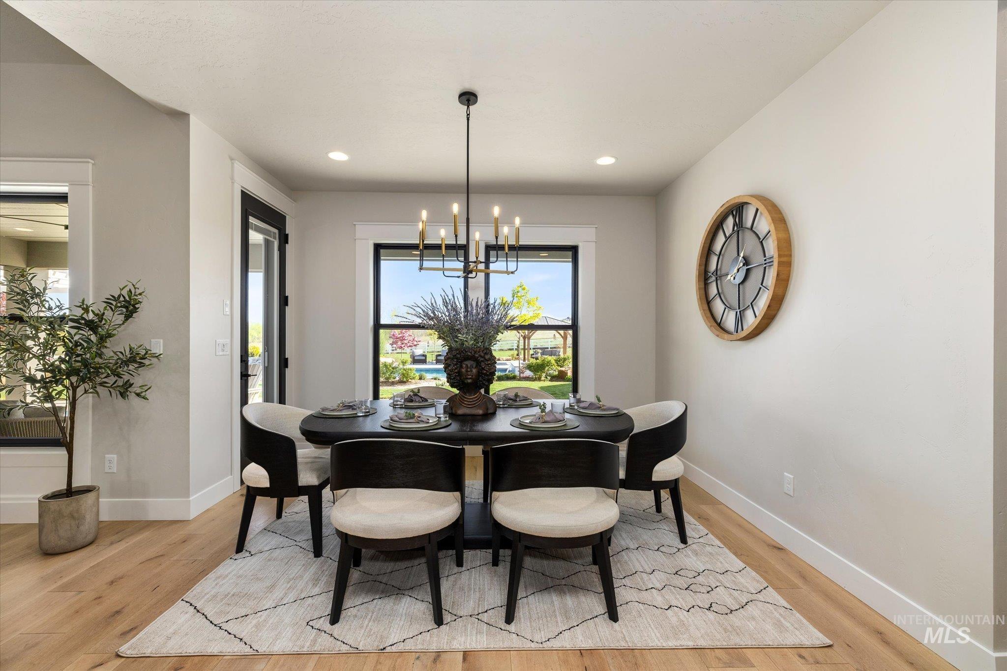 14857 Elk Spg Street Caldwell, ID 83607 - Photo 13 of 40 Dining space featuring a chandelier and light wood-type flooring