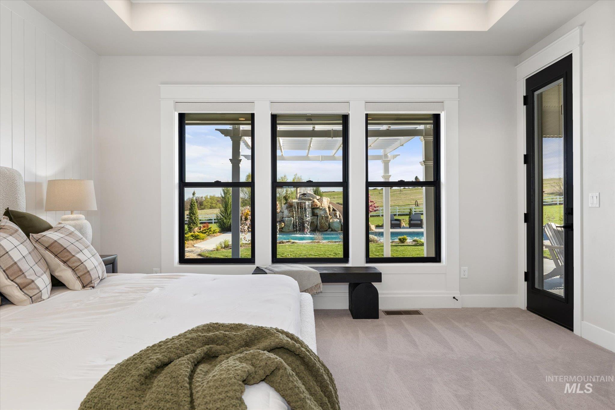 14857 Elk Spg Street Caldwell, ID 83607 - Photo 14 of 40 Bedroom featuring a raised ceiling, light carpet, and access to outside