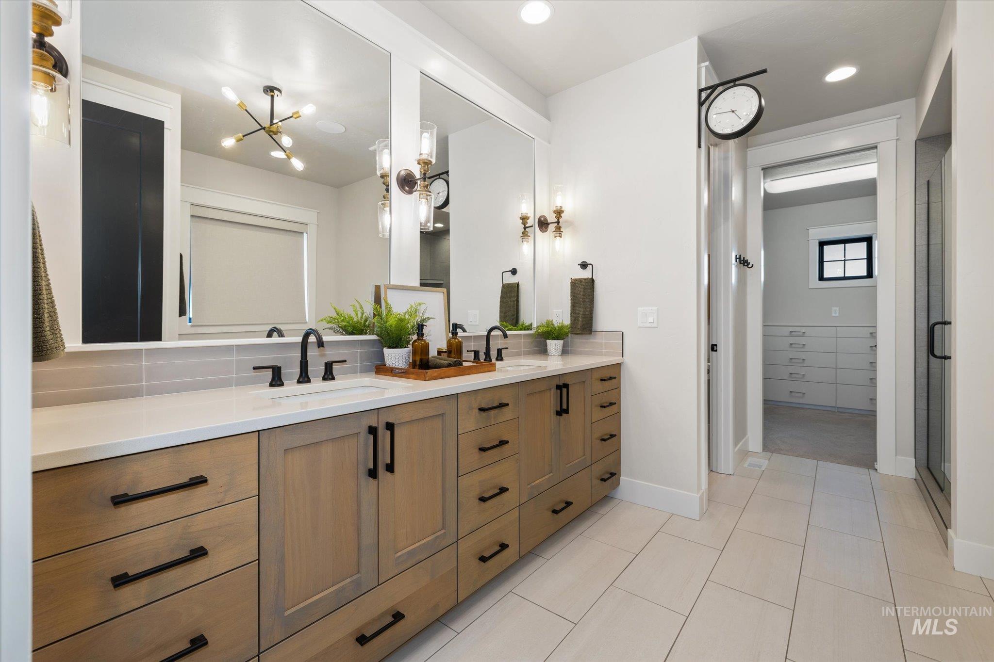 14857 Elk Spg Street Caldwell, ID 83607 - Photo 16 of 40 Bathroom with double vanity, a stall shower, tasteful backsplash, light tile patterned floors, and recessed lighting