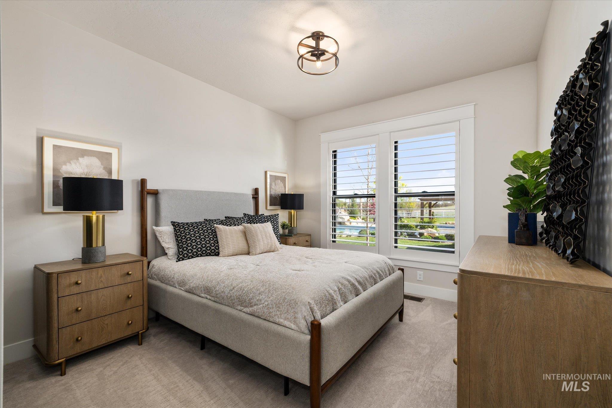 14857 Elk Spg Street Caldwell, ID 83607 - Photo 20 of 40 Bedroom featuring light carpet and baseboards
