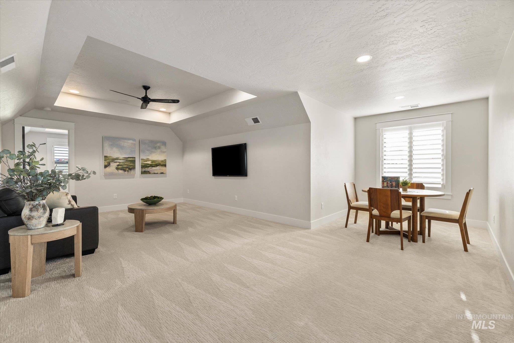 14857 Elk Spg Street Caldwell, ID 83607 - Photo 24 of 40 Living room featuring a raised ceiling, light colored carpet, plenty of natural light, recessed lighting, and a ceiling fan