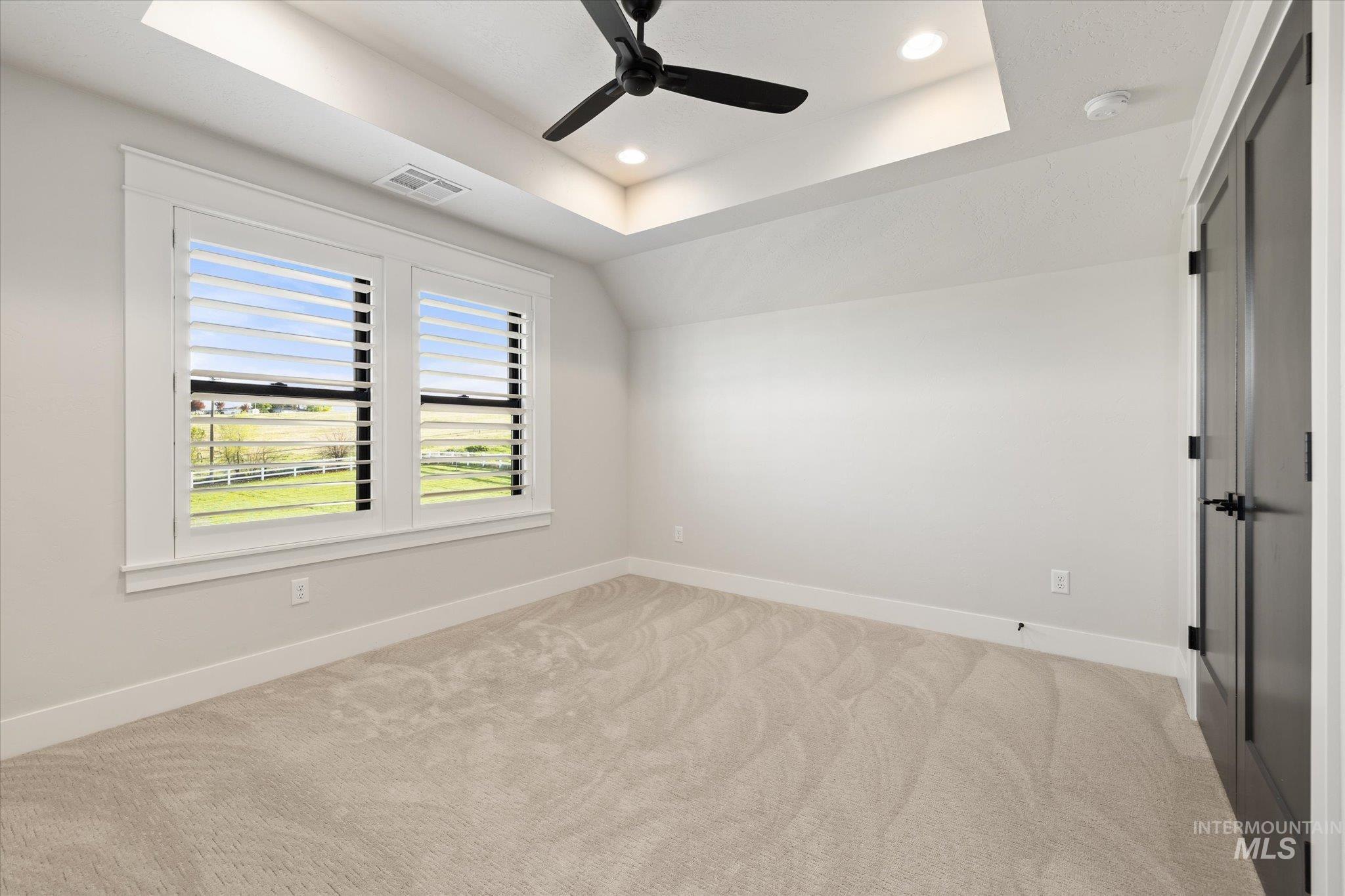 14857 Elk Spg Street Caldwell, ID 83607 - Photo 25 of 40 Empty room with recessed lighting, a raised ceiling, light carpet, ceiling fan, and vaulted ceiling