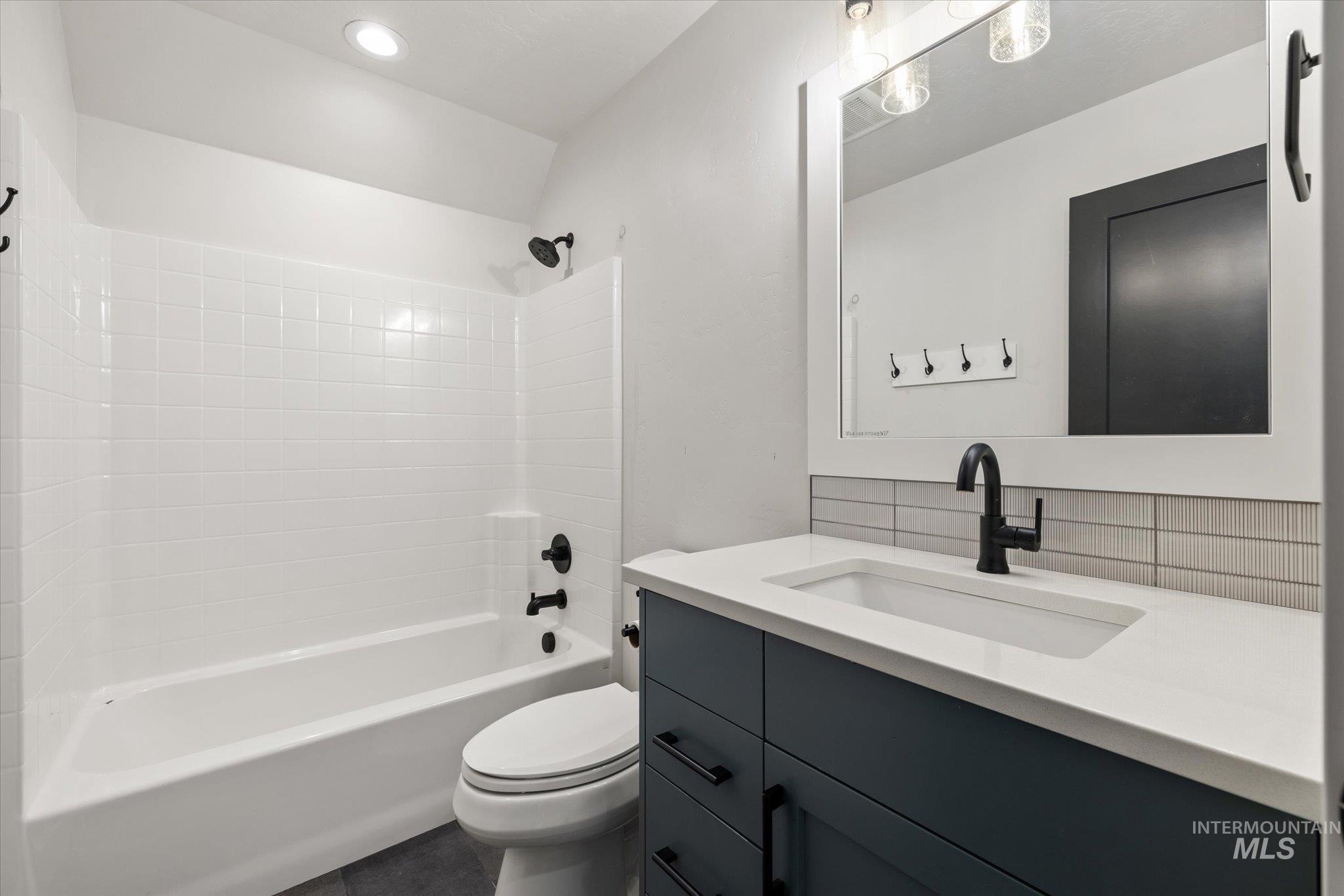 14857 Elk Spg Street Caldwell, ID 83607 - Photo 26 of 40 Bathroom with vanity, bathtub / shower combination, and decorative backsplash