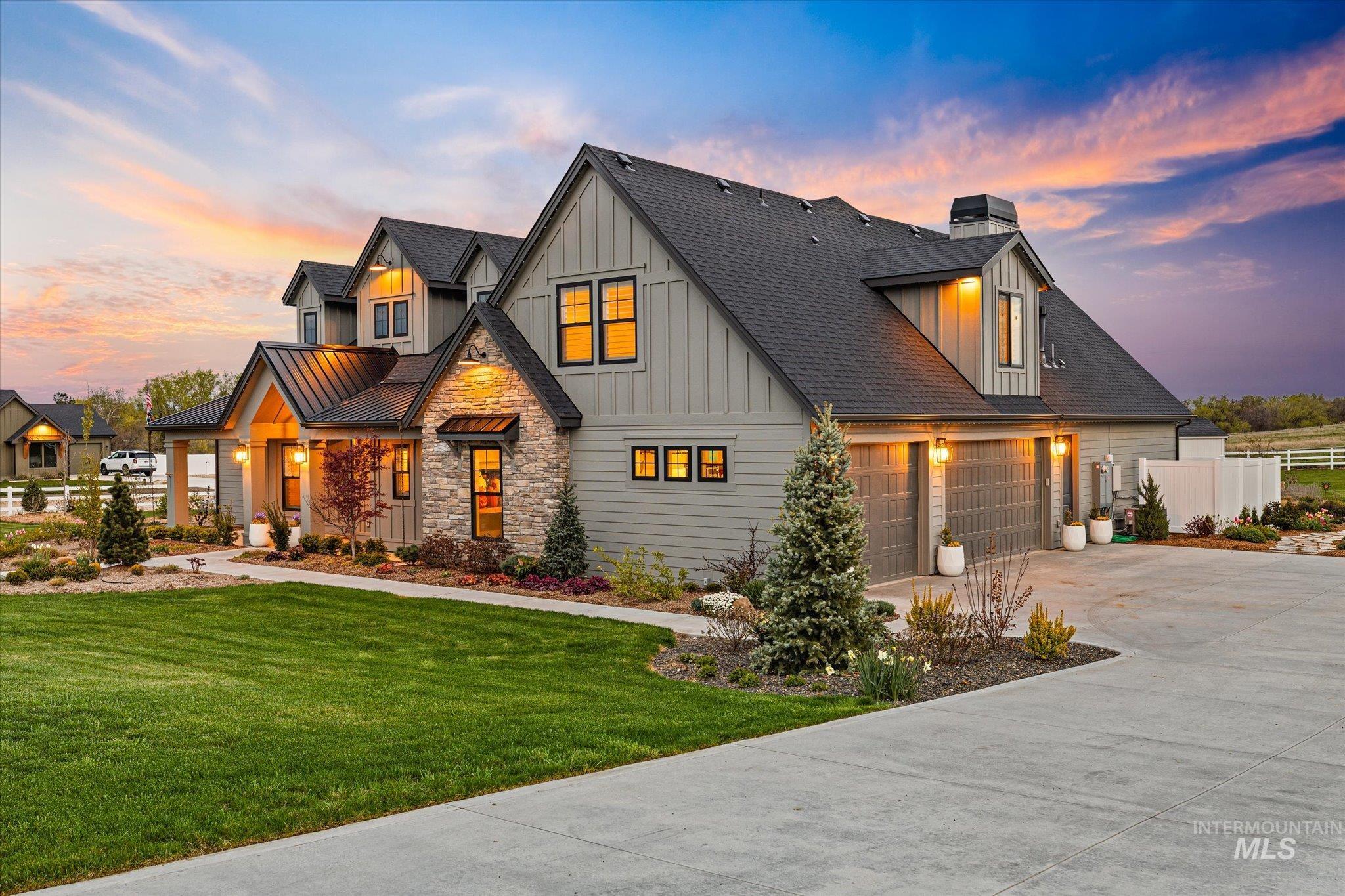 14857 Elk Spg Street Caldwell, ID 83607 - Photo 3 of 40 View of front of property featuring concrete driveway, board and batten siding, roof with shingles, a chimney, and stone siding