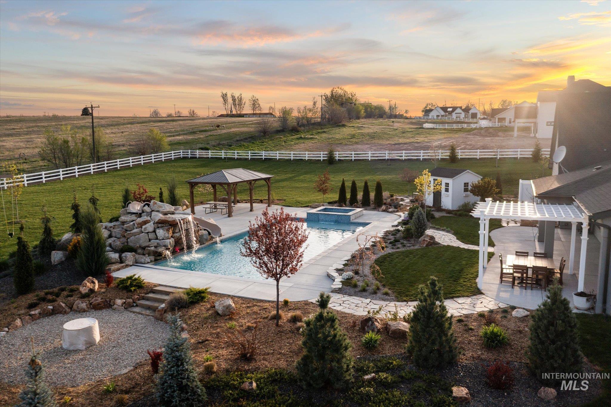 14857 Elk Spg Street Caldwell, ID 83607 - Photo 33 of 40 Integrated pool / hot tub featuring a fenced backyard, a patio area, a gazebo, and an outbuilding