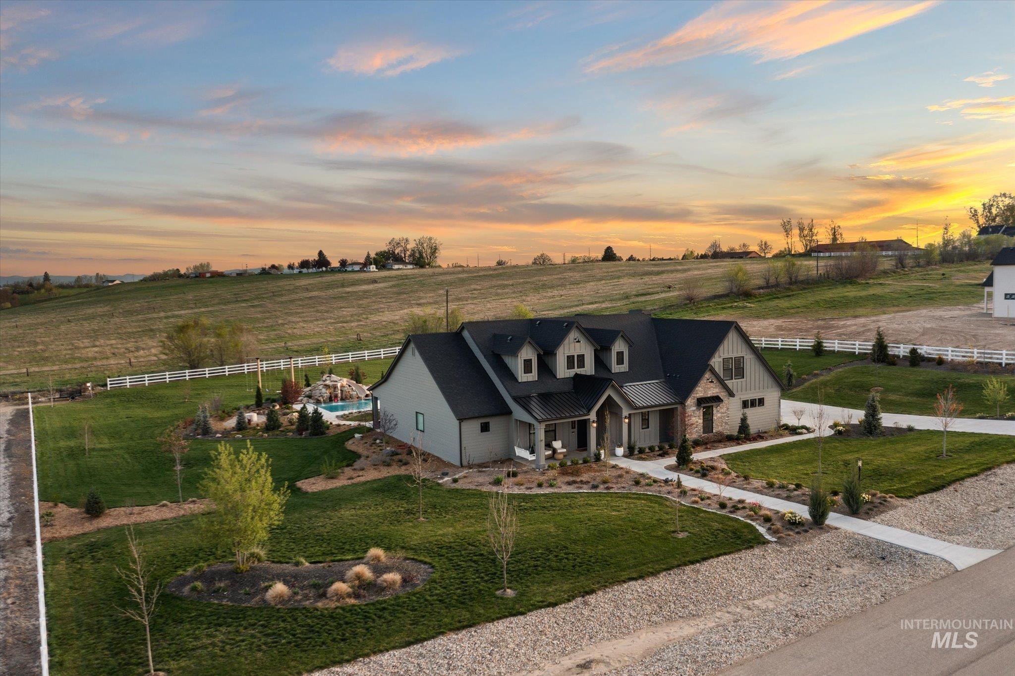 14857 Elk Spg Street Caldwell, ID 83607 - Photo 34 of 40 View of front of property with a porch, a view of rural / pastoral area, driveway, and a standing seam roof