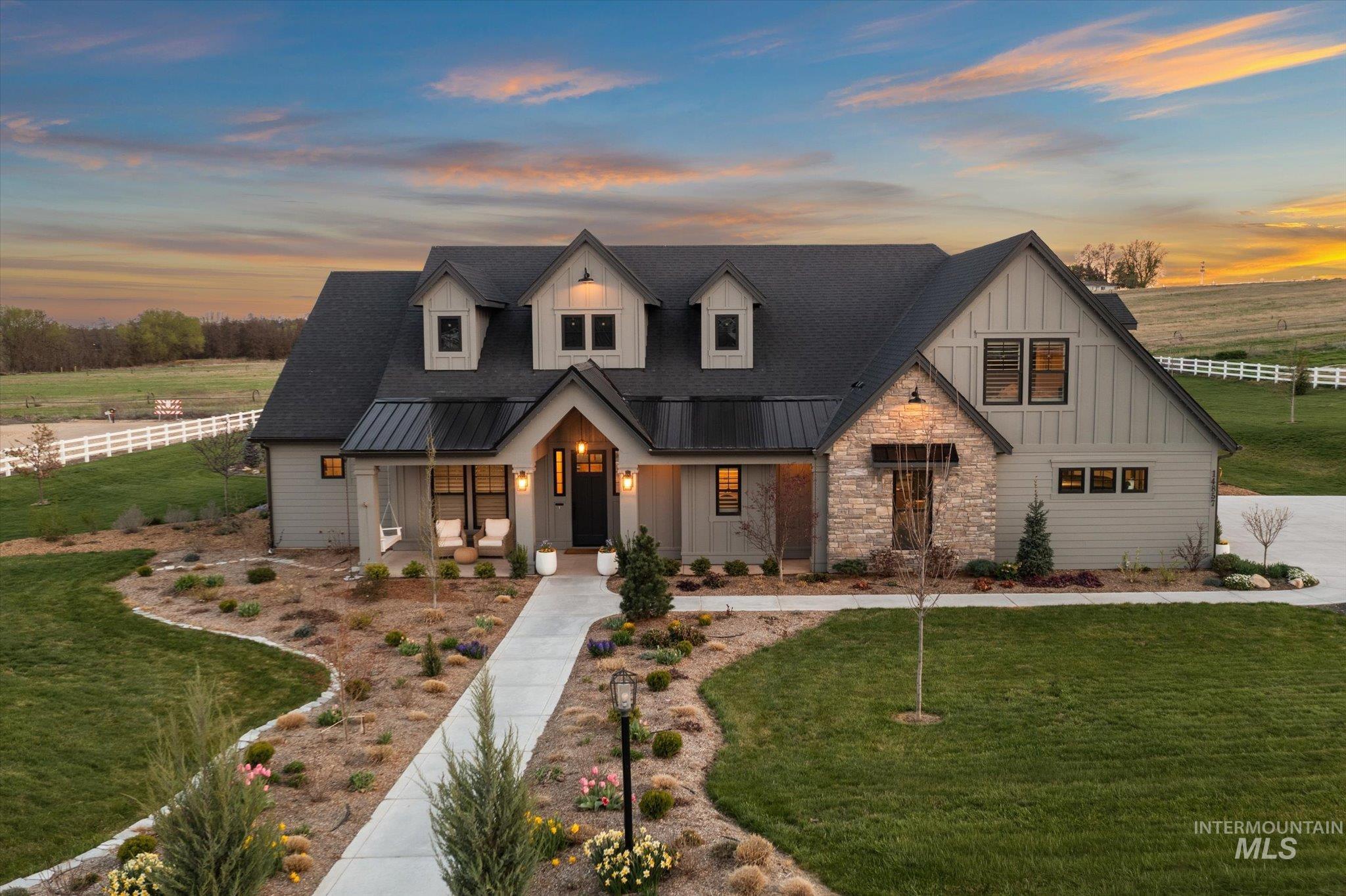 14857 Elk Spg Street Caldwell, ID 83607 - Photo 36 of 40 Modern farmhouse with covered porch, stone siding, a standing seam roof, and board and batten siding