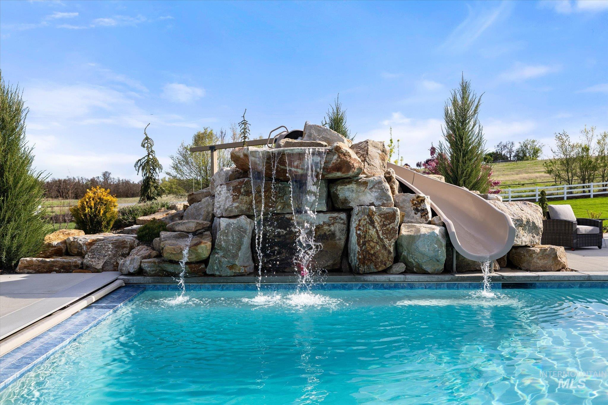 14857 Elk Spg Street Caldwell, ID 83607 - Photo 7 of 40 Outdoor pool with a water slide and a patio area