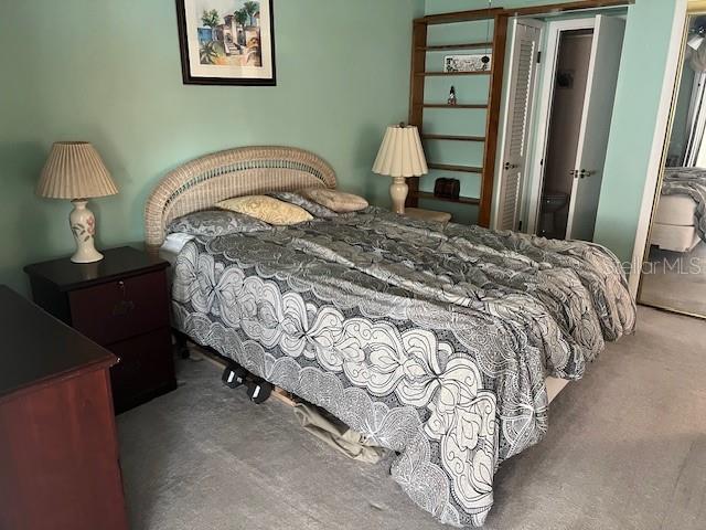 4758 Jasper Drive, Unit 206 New Port Richey, FL 34652 - Photo 7 of 34 a bedroom with a bed and a lamp on table