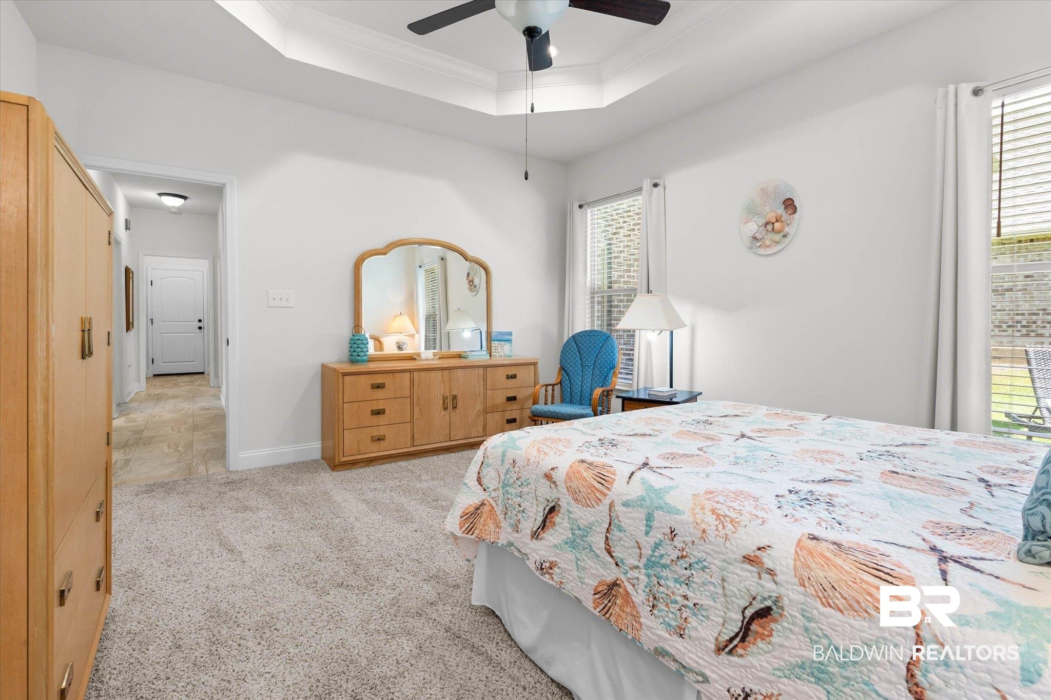 1270 Surrey Loop Foley, AL 36535 - Photo 14 of 27 Spacious bedroom featuring light-colored carpeting, a tray ceiling with a ceiling fan, and two windows with blinds