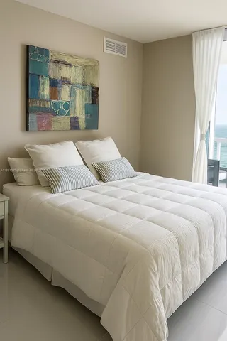 a bedroom with a bed and a night stand