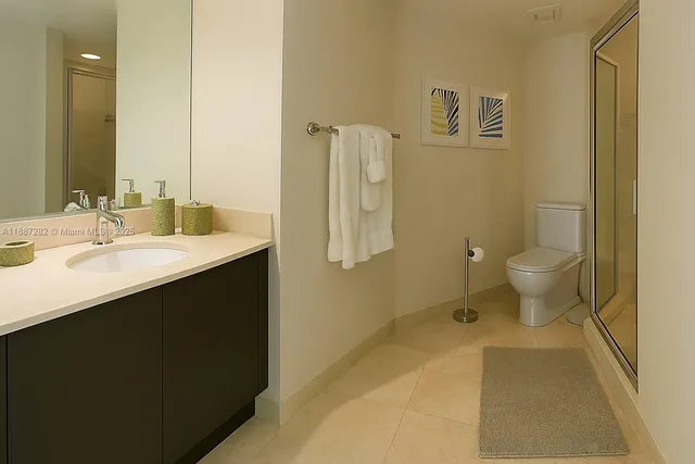 a bedroom with 2 bed and a flat screen tv