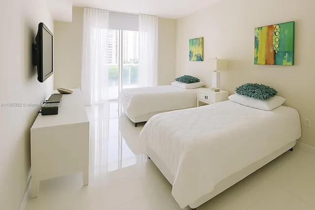 a bedroom with a bed and a flat screen tv