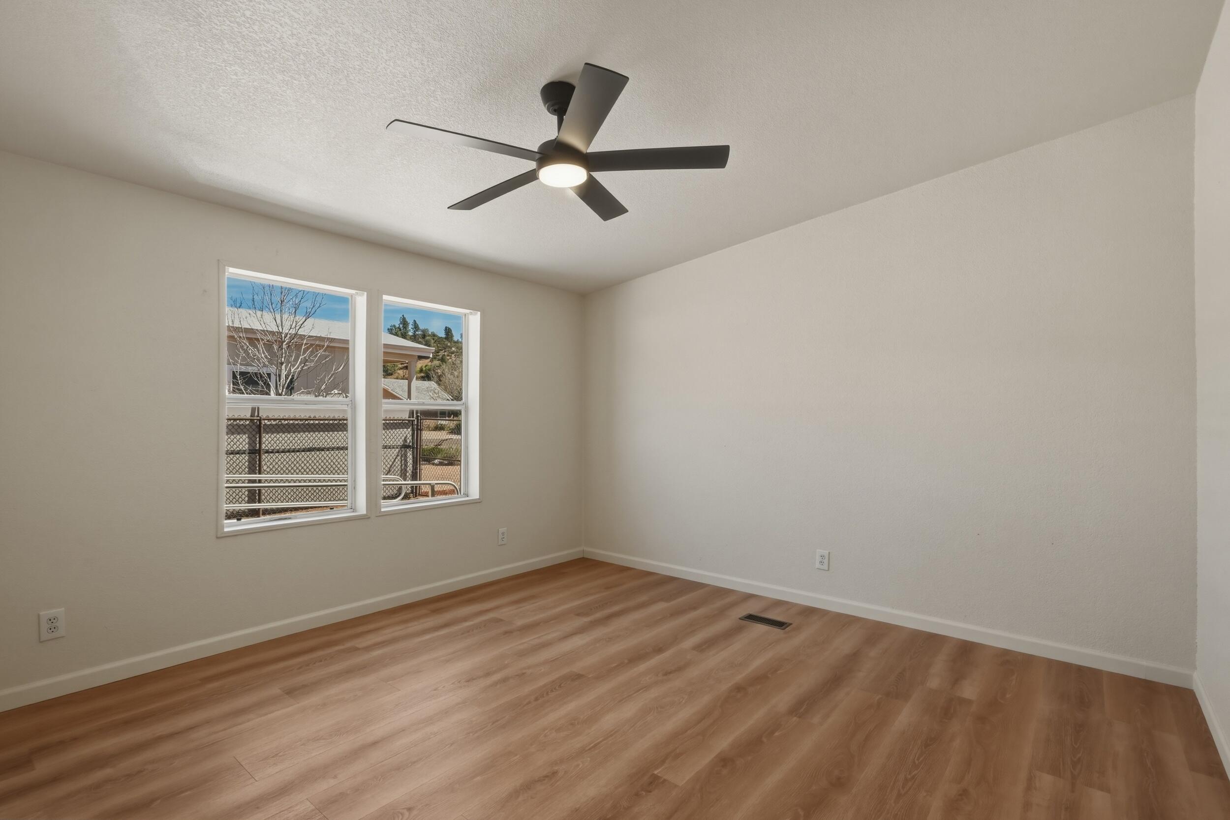312 East Cedar Milll Road Star Valley, AZ 85541 - Photo 18 of 27 a view of empty room with wooden floor and fan