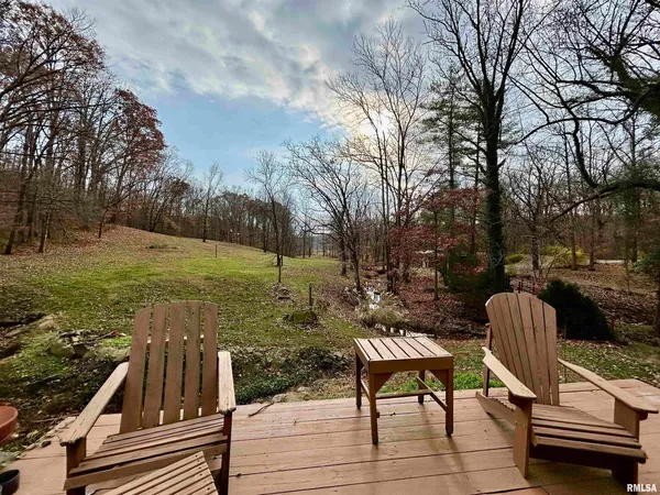 a view of a yard with furniture and trees
