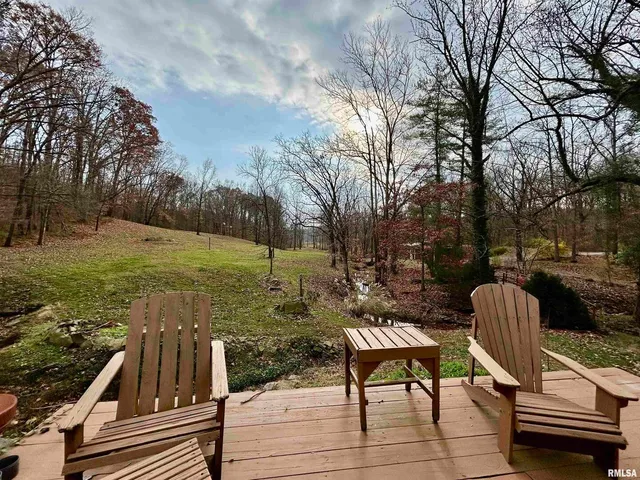 a view of a yard with furniture and trees