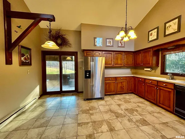 a kitchen with stainless steel appliances granite countertop a refrigerator and a sink
