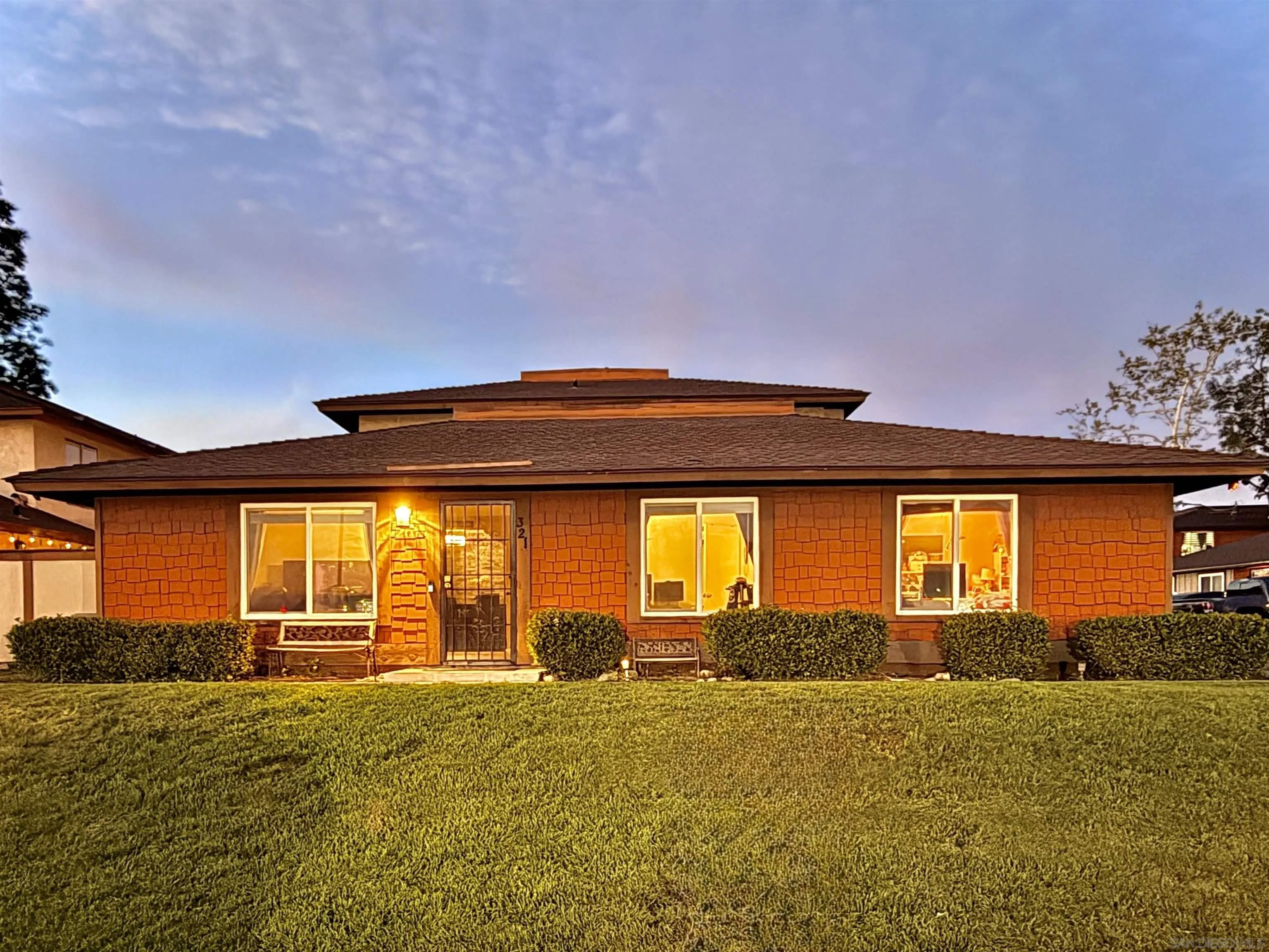 a front view of house with yard and outdoor seating
