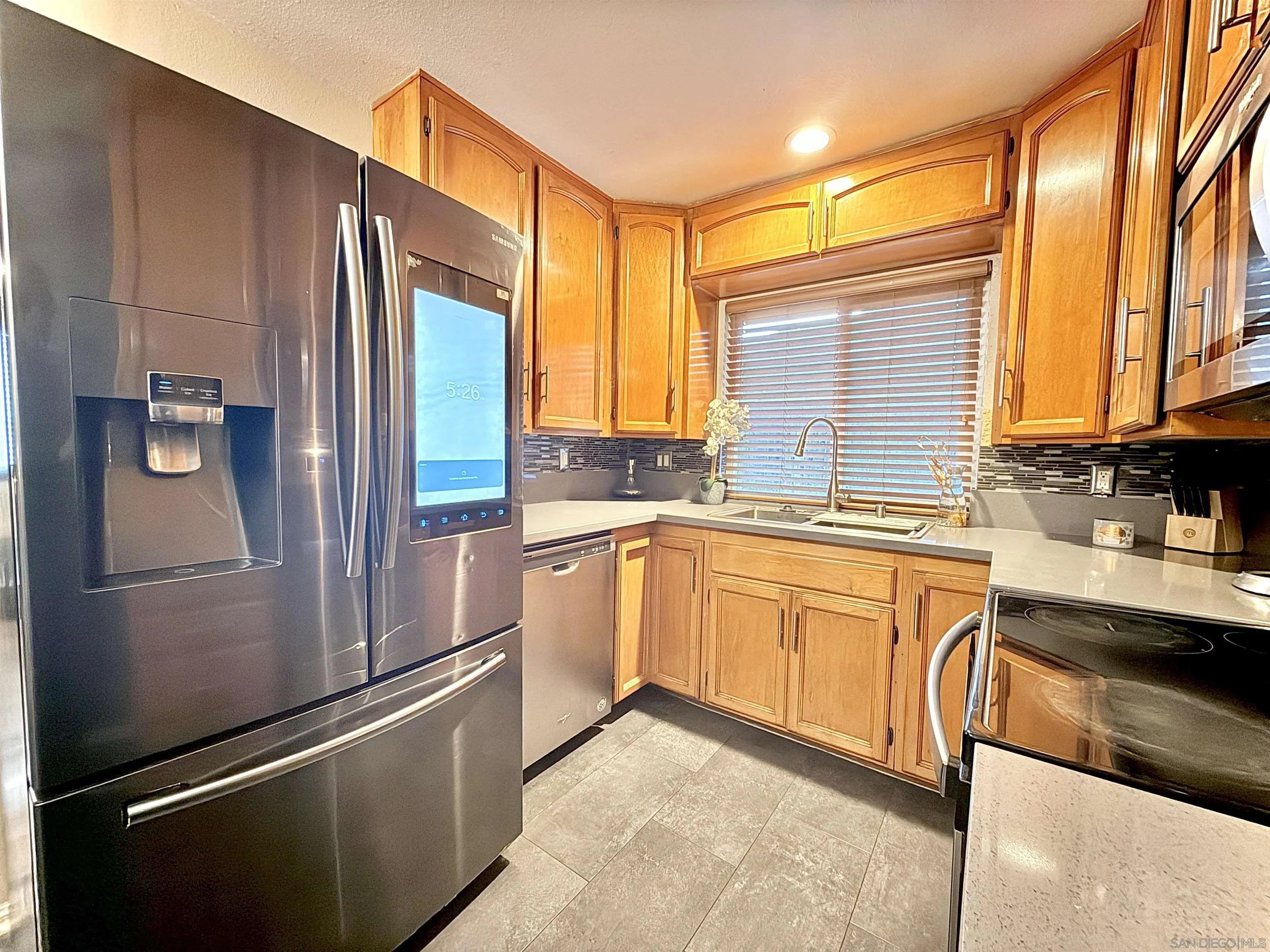321 Sun Court El Cajon, CA 92021 - Photo 6 of 33 a kitchen with stainless steel appliances granite countertop a refrigerator and a sink