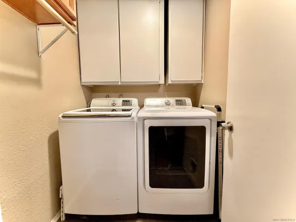 a utility room with a sink washer and dryer