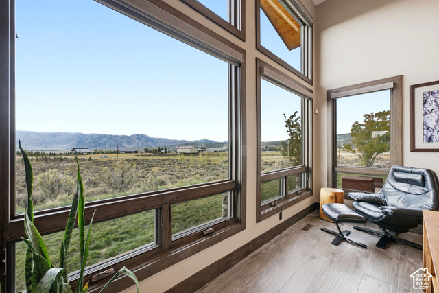 1130 Pace Road Park City, UT 84098 - Photo 11 of 73 Expansive window wall with dark wood-finish framing, wood-finish flooring, and high ceilings