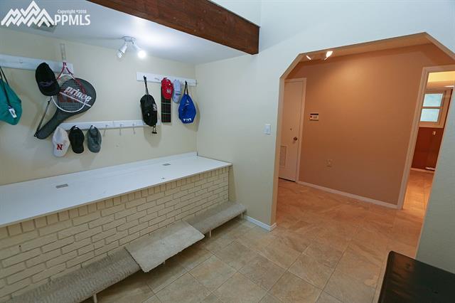 3123 Springdowns Place Colorado Springs, CO 80906 - Photo 22 of 36 Entryway/mudroom with garage, laundry, and bathroom nearby. Newer tile and tall ceilings.
