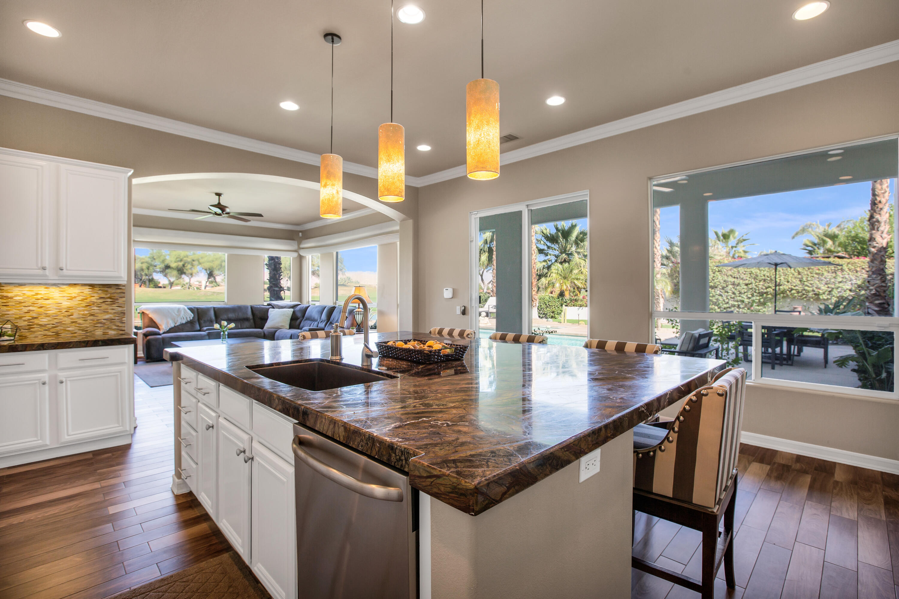 390 Loch Lomond Road Rancho Mirage, CA 92270 - Photo 17 of 55 a large kitchen with granite countertop a large center island in it