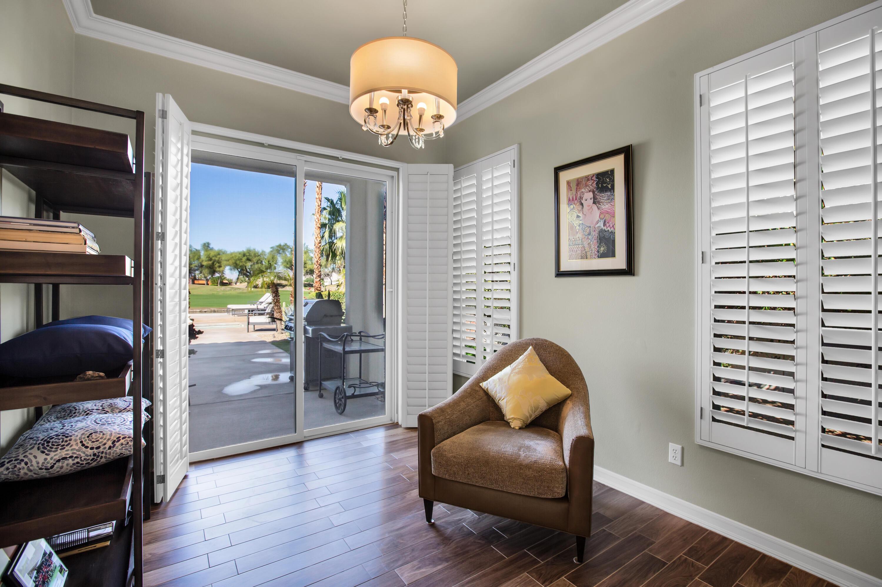 390 Loch Lomond Road Rancho Mirage, CA 92270 - Photo 26 of 55 a living room with furniture and a chandelier