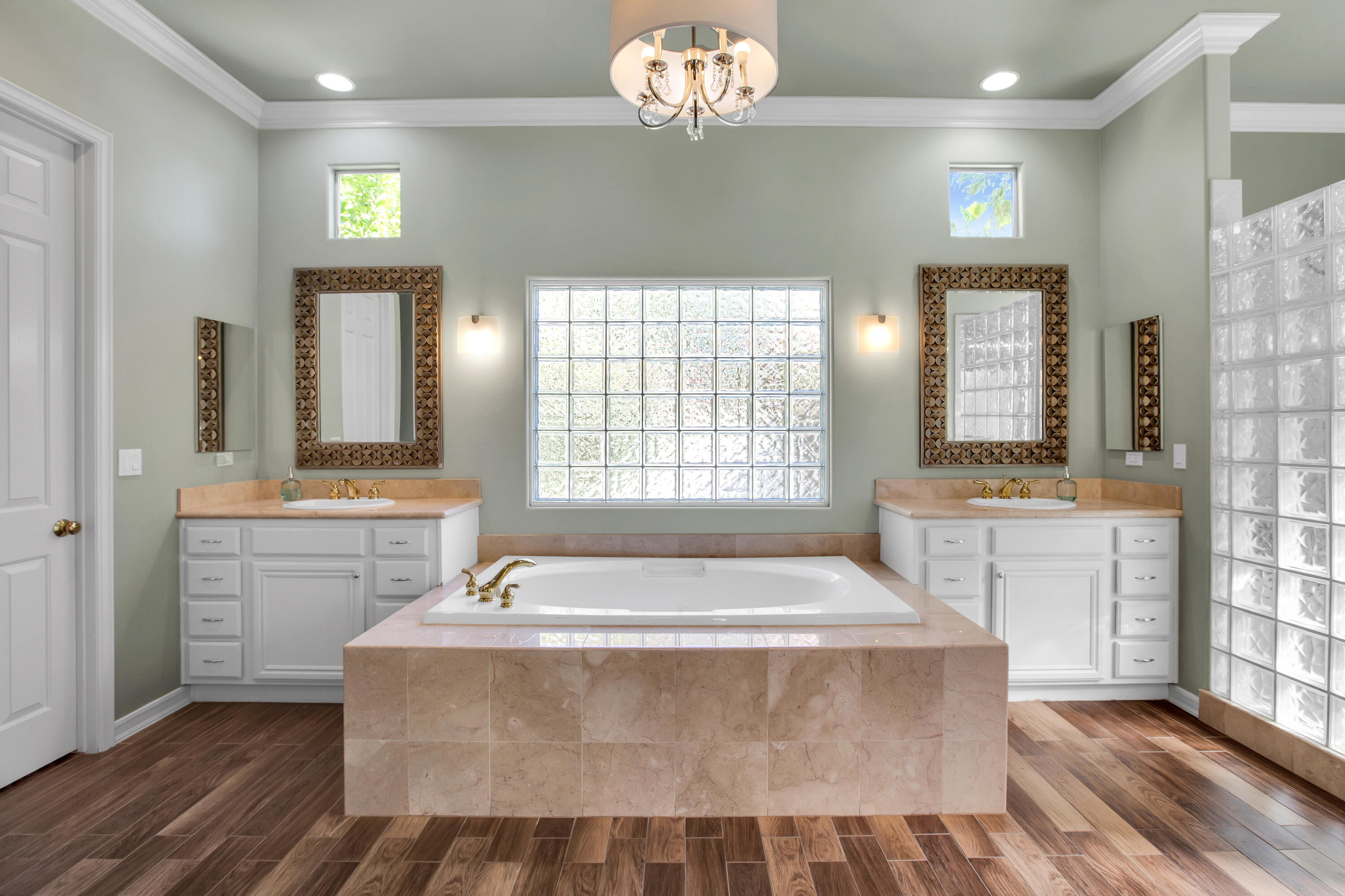 390 Loch Lomond Road Rancho Mirage, CA 92270 - Photo 28 of 55 a spacious bathroom with a granite countertop sink a large mirror a bathtub and window