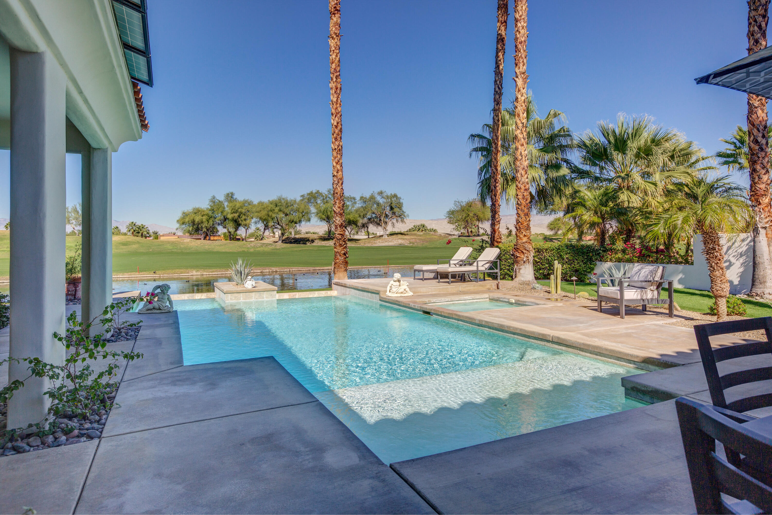 390 Loch Lomond Road Rancho Mirage, CA 92270 - Photo 40 of 55 a view of a swimming pool with a lounge chairs