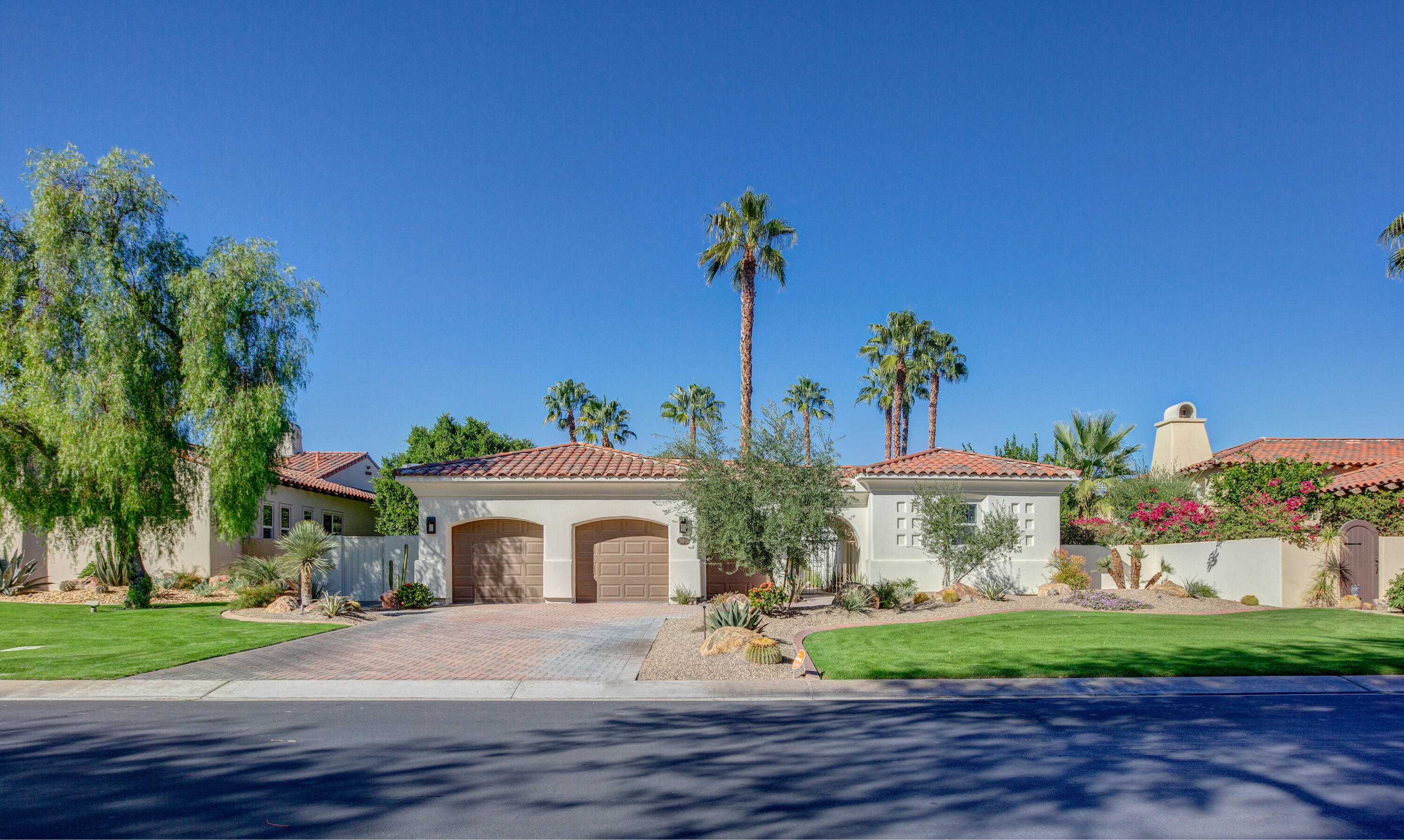 390 Loch Lomond Road Rancho Mirage, CA 92270 - Photo 5 of 55 a front view of a house with a garden and a yard
