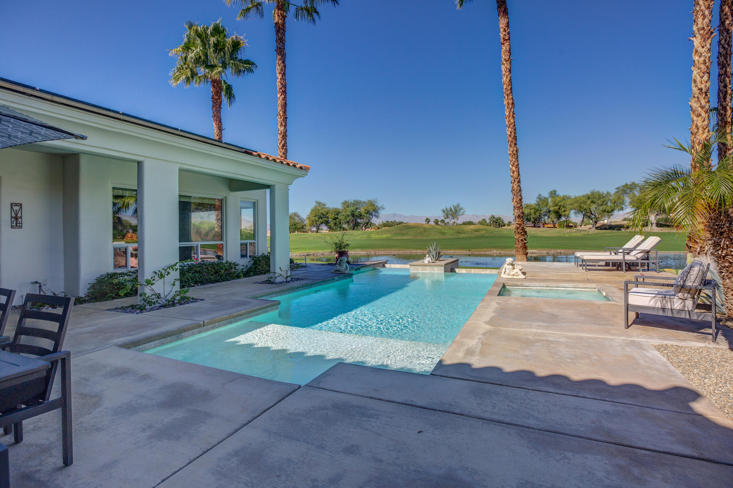 390 Loch Lomond Road Rancho Mirage, CA 92270 - Photo 42 of 55 a view of a swimming pool with a lounge chairs