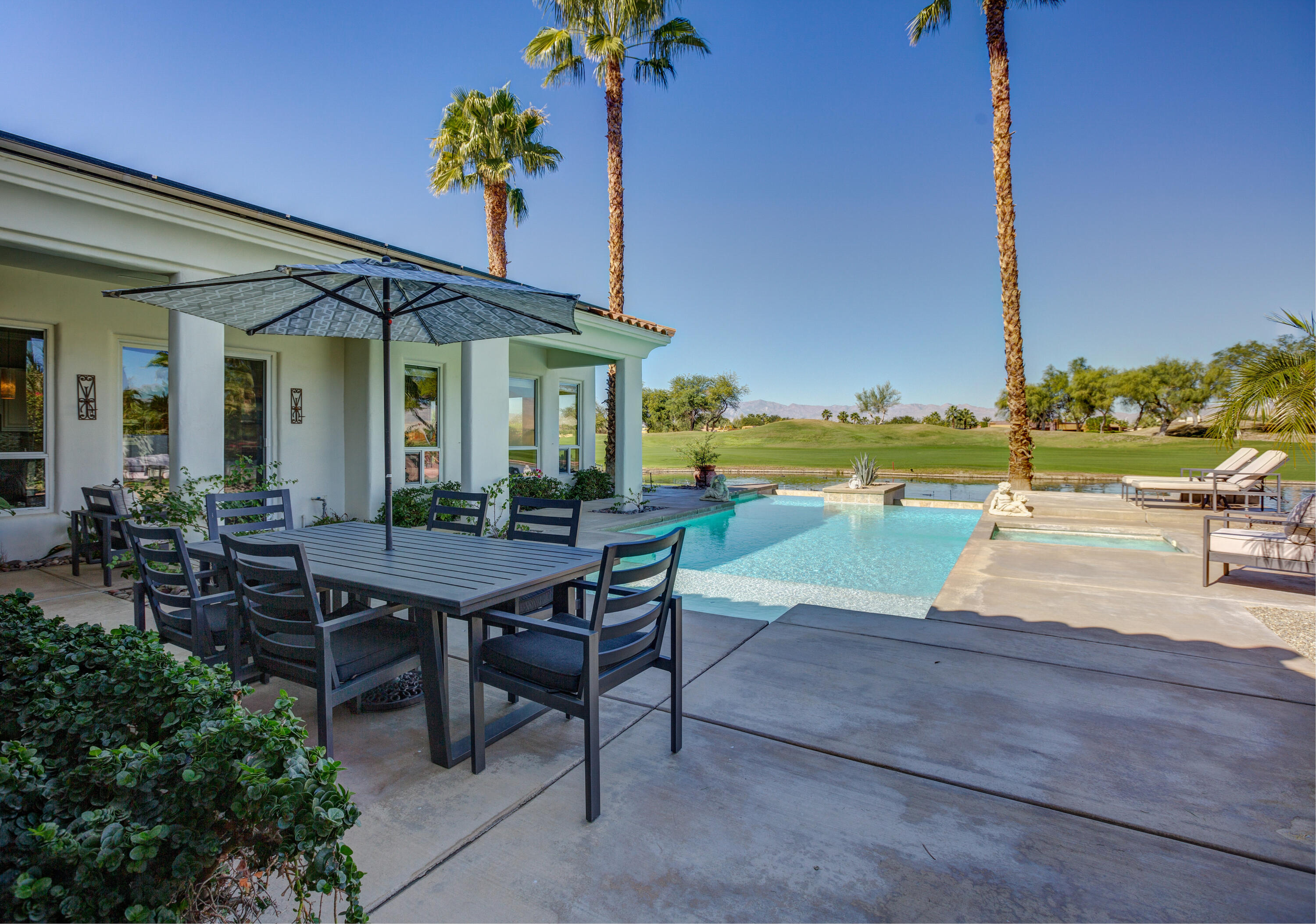 390 Loch Lomond Road Rancho Mirage, CA 92270 - Photo 43 of 55 a view of a patio with a table and chairs