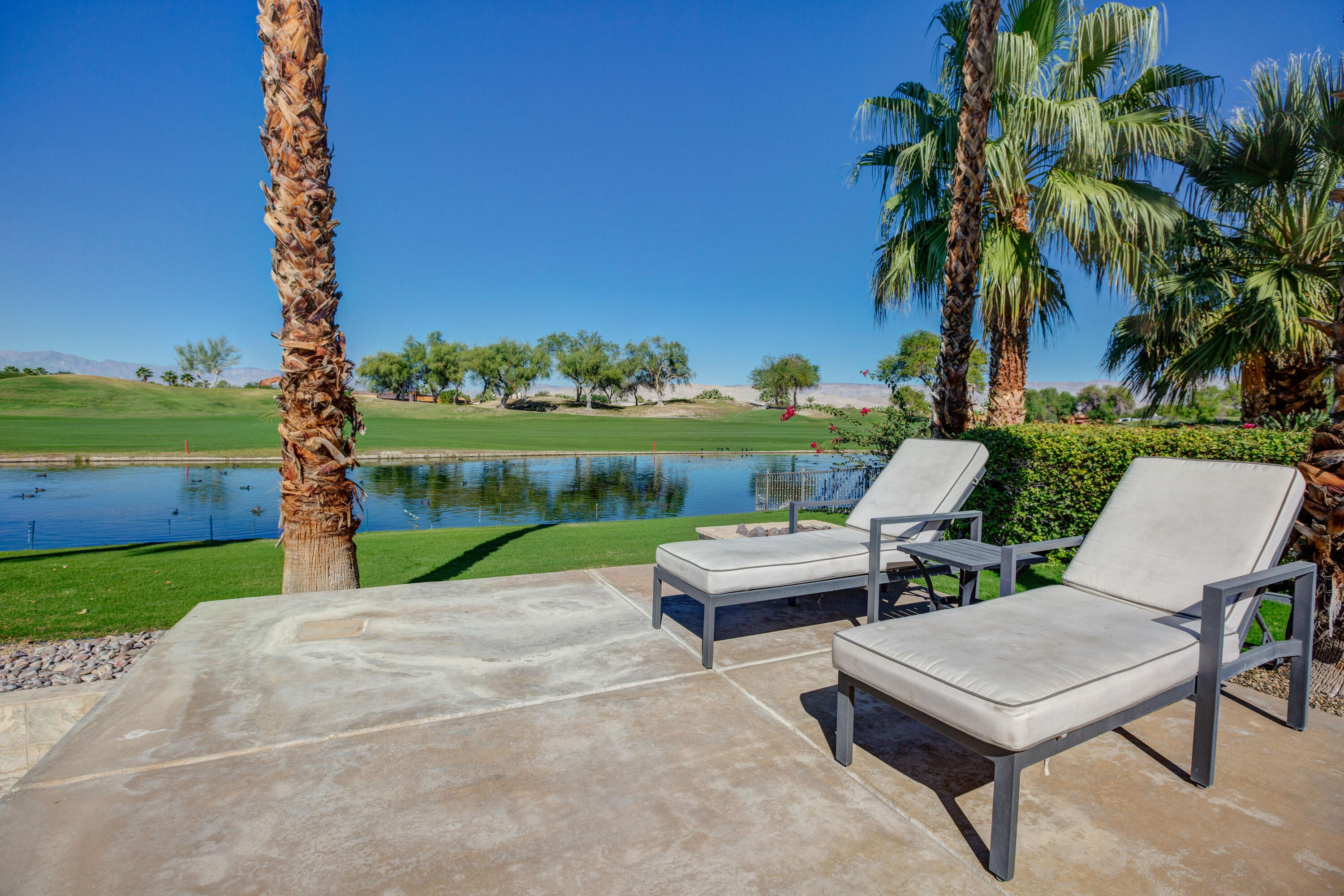 390 Loch Lomond Road Rancho Mirage, CA 92270 - Photo 50 of 55 a view of a patio with a table and chairs