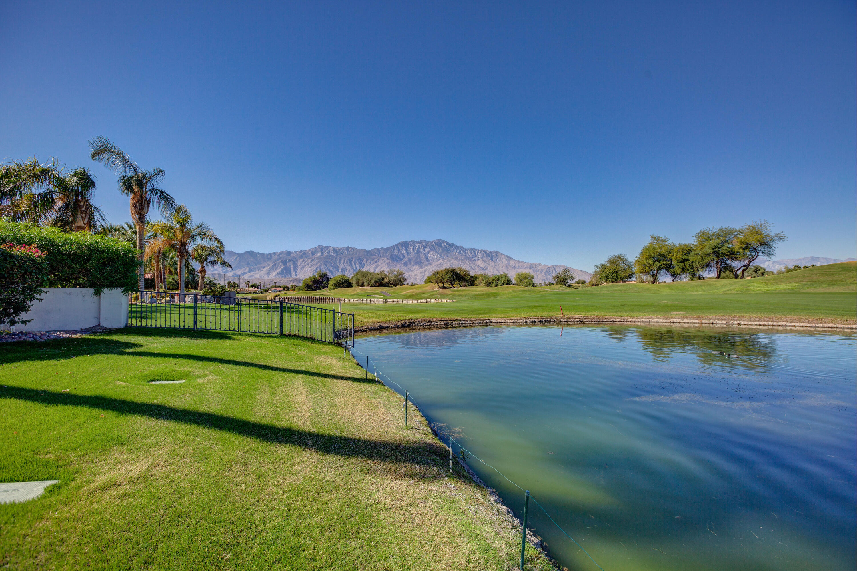 390 Loch Lomond Road Rancho Mirage, CA 92270 - Photo 53 of 55 a view of a lake with houses in the back