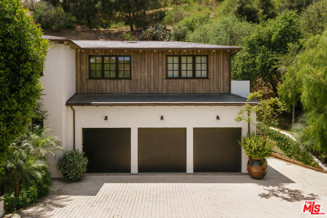 1105 Rivas Canyon Road Pacific Palisades, CA 90272 - Photo 5 of 49 a front view of a house with a yard