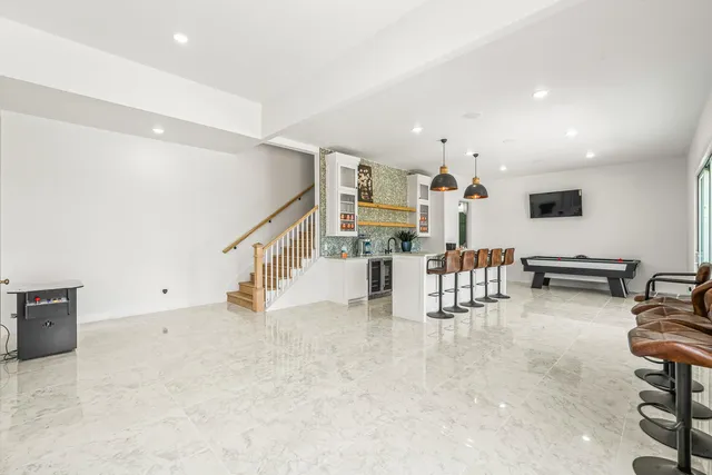 a kitchen with a sink a washer and dryer next to a window