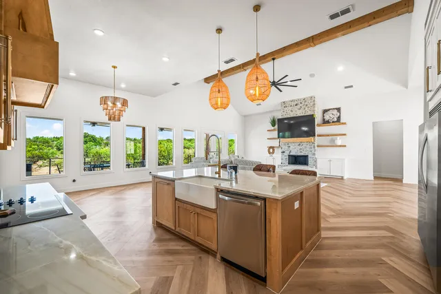 a bathroom with a granite countertop sink a mirror and shower